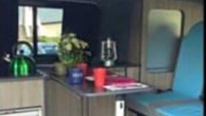 A compact kitchenette with a sink, a small countertop, and a window. - Pembs Campervan VW T5 Travel and Stay in Style (Haverfordwest)