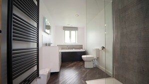 A modern bathroom with a shower, toilet, and sink. - Hot Tub*,Fire, Super-king , Zip n Link beds.Views (PRESTON)