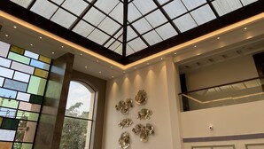 A modern interior with a skylight, decorative ceiling, and wall-mounted art. - Grand Victoria The Fern Resort & Spa, Panchgani (Wai)