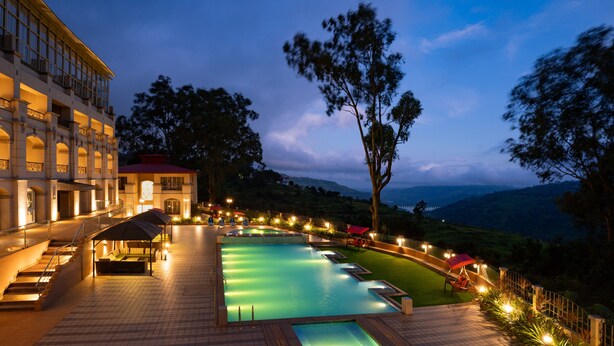 A hotel with a swimming pool, outdoor seating, and a view of the surrounding landscape. - Grand Victoria The Fern Resort & Spa, Panchgani (Wai)