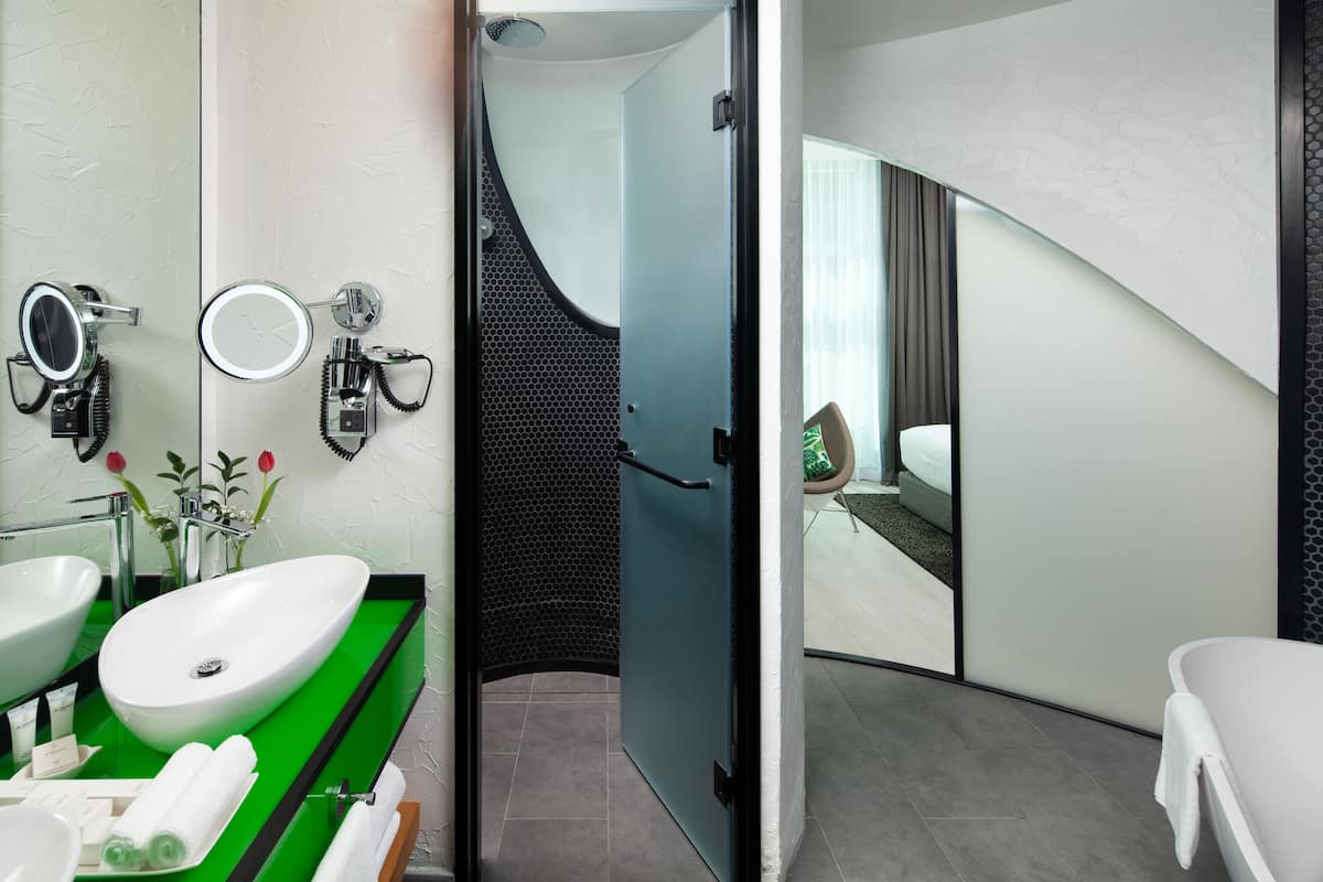 sky garden suite | bathroom | hair dryer, bathrobes, slippers, bidet