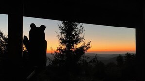 Silueta de una persona contra un atardecer con vistas a la montaña.