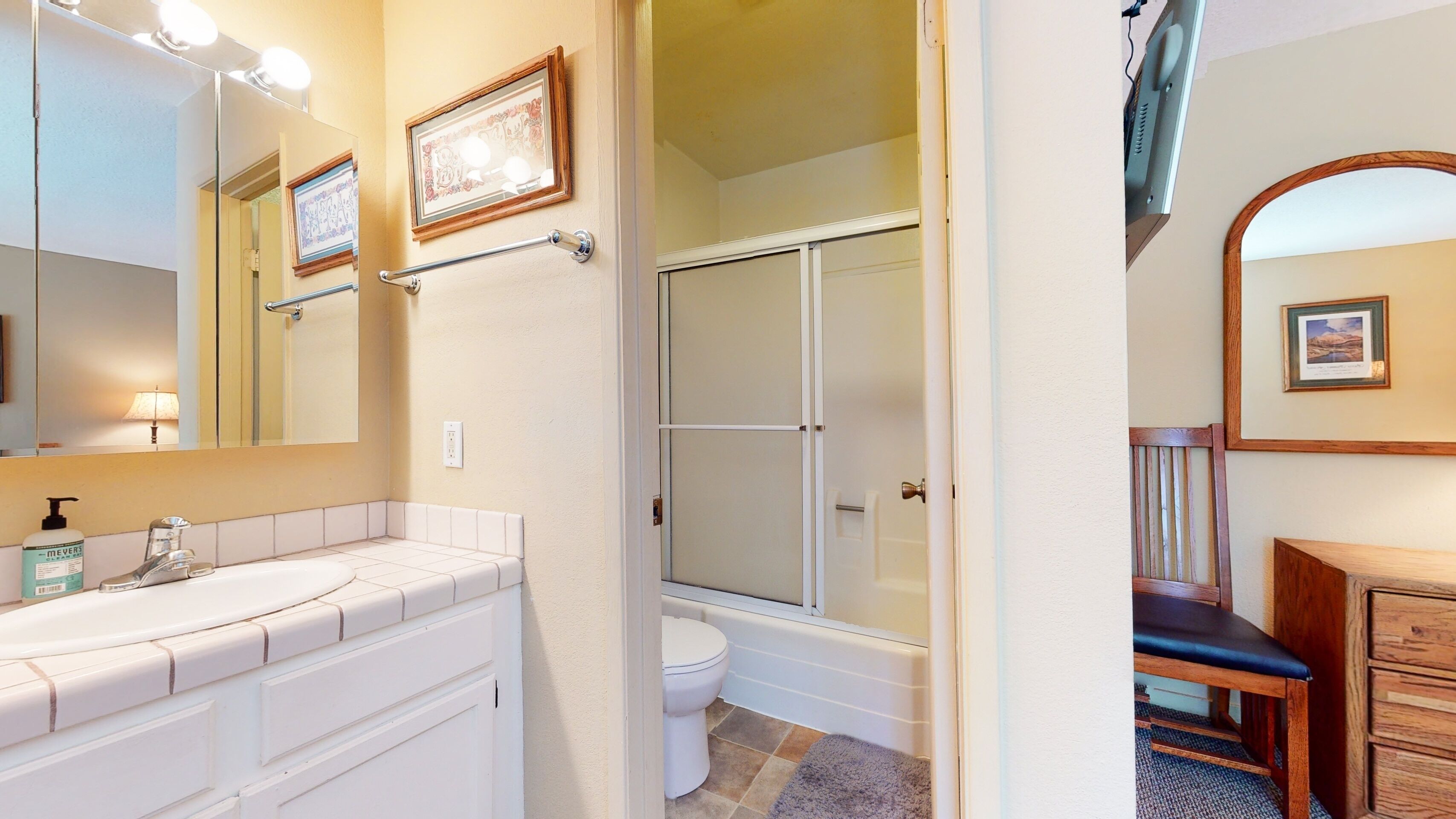 Une salle de bain équipée d’un meuble-lavabo, d’une douche et de toilettes.