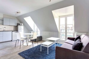 Um apartamento moderno estilo loft, com cozinha, sala de jantar e área de estar.