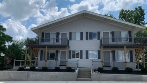 A two-story building with a flat roof, large windows, and balconies. - Adventure Acres- Suite C8  (Holly)