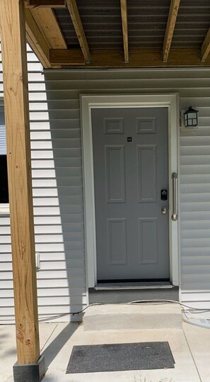 Secure entrance with electronic keypad lock and slatted frame.