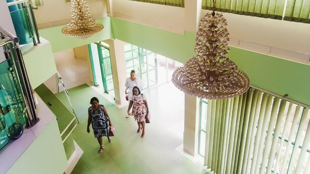 A spacious atrium with high ceilings, large windows, and hanging chandeliers. - Korkdam Hotel (Accra)
