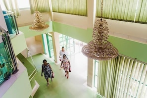 A spacious atrium with high ceilings, large windows, and hanging chandeliers. - Korkdam Hotel (Accra)