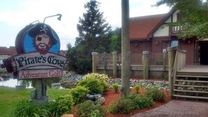 A sign for 'Pirate's Cove Adventure Golf' with a pirate-themed design.