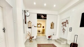 A spacious hallway with a patterned rug, a clock, and a suitcase. - Astonishing Studio for 2 people in the Heart of Naples 3P (Napoli)