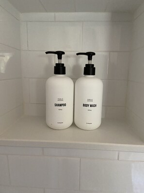 Bathtub, hair dryer, towels, soap