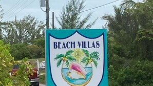 A sign for Beach Villas Private, indicating an entrance to a private property.