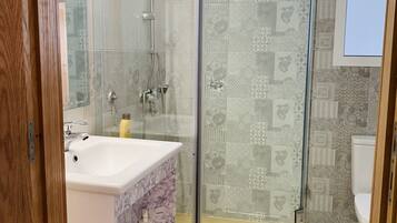 Shower, towels, soap, toilet paper