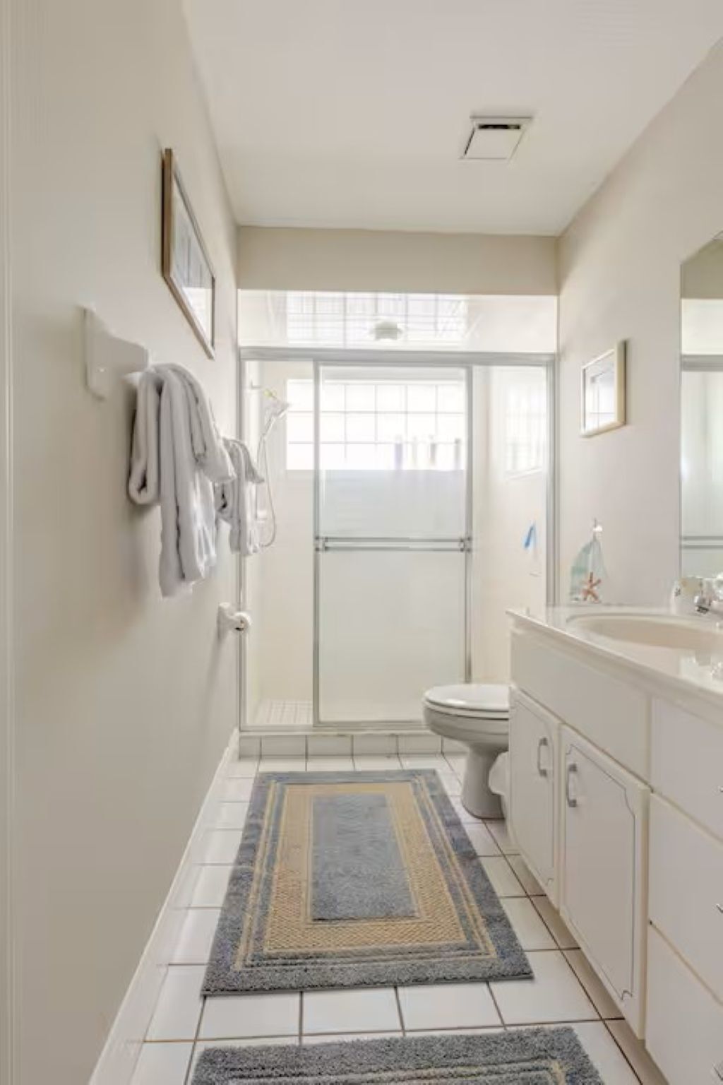 A bathroom with a shower, toilet, and sink.