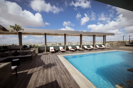 Outdoor pool, open 8:00 AM to 6:00 PM, lifeguards on site