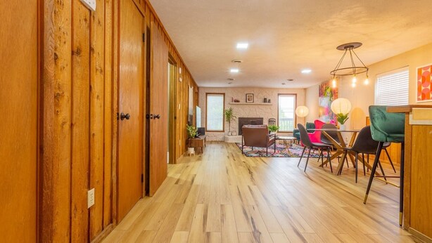 A spacious room with wooden flooring, a dining area with modern chairs, and a fireplace. - ACID WASH @ DOLLYS DRIVE * Wifi Grill Woods Mtns (Sevierville)
