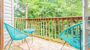 A wooden deck with a railing, two turquoise chairs, and a small table. - PSYCHEDELIC @ DOLLYS DRIVE * Wifi Grill Woods Mtns (Sevierville)