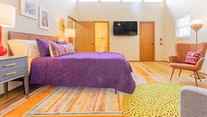 A bedroom with a bed, a chair, a TV, and a ceiling fan. - PSYCHEDELIC @ DOLLYS DRIVE * Wifi Grill Woods Mtns (Sevierville)
