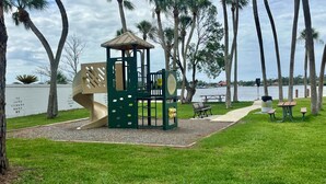 A playground with a slide, climbing area, and a small shelter. - Quiet area and canoeing steps away from the front door. (Port Richey)