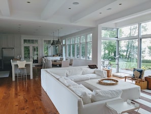 Enjoy a spacious living area with a large sofa and dining table, offering a view of the outdoors.