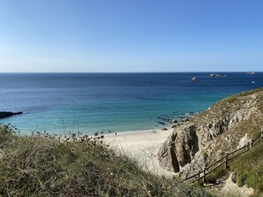 A coastal beach with rocky terrain and a wooden staircase leading down to the shore. - Maisonnette close to the sea *** (Plougonvelin)