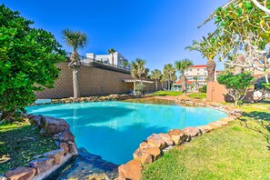 Surrounded by lush greenery, this serene pool area offers a tranquil ambiance.