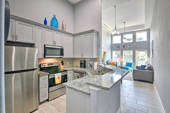 Enjoy cooking in this well-equipped kitchen with stainless steel appliances, granite countertops, and ample storage.