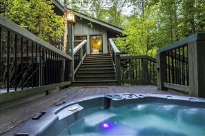 Relax in a hot tub surrounded by a wooden deck.