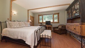 A bedroom with a bed, a wooden cabinet, a chair, and a window. - Perfect Mountain Home II with HOT TUB overlooking Mary's Lake/Near RMNP entrance (Estes Park)