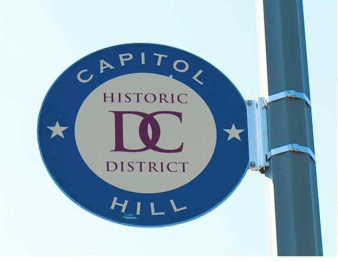 A circular sign with the text "Capitol Hill Historic District" and a logo.