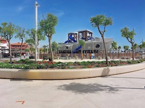 A modern building with a blue slide and a covered seating area.