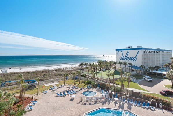 A resort with a pool, beach view, and a building labeled "The Island". - Destin West Gulfside 506 ~ Amazing Beach and Pool Views! (Fort Walton Beach)