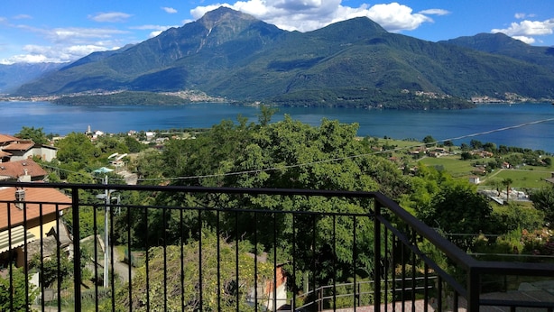 Un paisaje montañoso con un lago y un pueblo en primer plano.