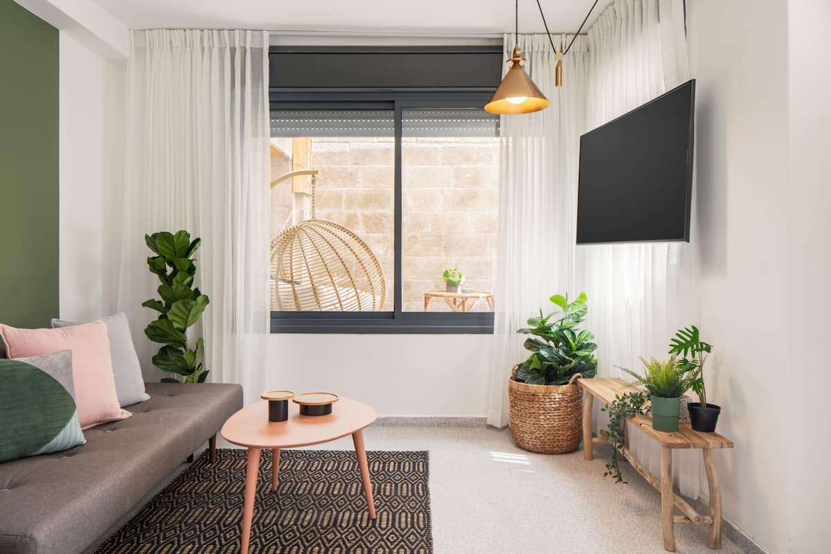 Deluxe Apartment, 1 Bedroom | Living area | 42-inch Smart TV with cable channels, TV