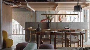 A modern living space with a dining area, sofas, and a kitchen in the background. - Buckle Street Studios by Locke, Aldgate (London)