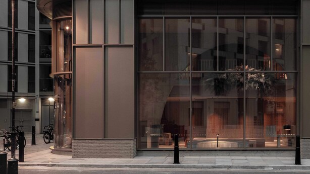 A modern building facade with large windows, a visible entrance, and a bicycle parking area. - Buckle Street Studios by Locke, Aldgate (London)