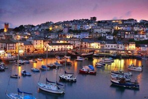 A harbor with boats, buildings, and a church.
