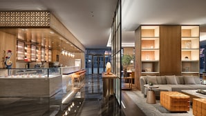 A modern hotel lobby with a bar area, seating, and a large window providing a view of the cityscape. - Crowne Plaza Hohhot City Center by IHG (Hohhot)