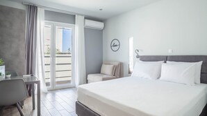 Habitación de hotel moderna con una cama grande, un escritorio y una silla.