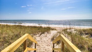 A sandy beach with wooden pathways leading to the ocean. - ☀️Next Time Down: Oceanfront Home w/ Deck-Private Beach Access☀️ (Kure Beach)
