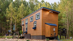 A wooden cabin with a gabled roof, multiple windows, and a small porch area. - True Tiny Home & Community l 4 Mi To Mentone (Mentone)