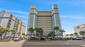 A tall hotel with a modern design, featuring multiple floors and a prominent entrance. - Boardwalk Beach Resort #932 Gorgeous1 Bedroom Oceanfront Condo (Myrtle Beach)
