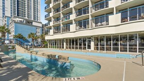 A hotel with a pool area, multiple balconies, and a view of other buildings. - Boardwalk Beach Resort #932 Gorgeous1 Bedroom Oceanfront Condo (Myrtle Beach)