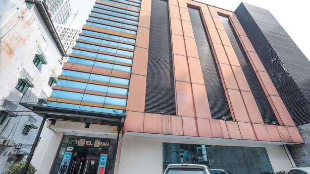A modern hotel building with a prominent entrance, large windows, and a visible sign for the hotel named "HOTEL MIRAH". - OYO 172 Gunung Sahari 12 Residence (Jakarta)