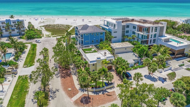An aerial view of a coastal hotel with multiple buildings, a beach, and a pool area. - Luxury Pool and Rooftop Deck, Walk to Siesta Key Beach and Village! - Casa Siest (Siesta Key)