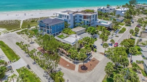 A coastal hotel with multiple buildings, a beach view, and a parking area. - Luxury Pool and Rooftop Deck, Walk to Siesta Key Beach and Village! - Casa Siest (Siesta Key)