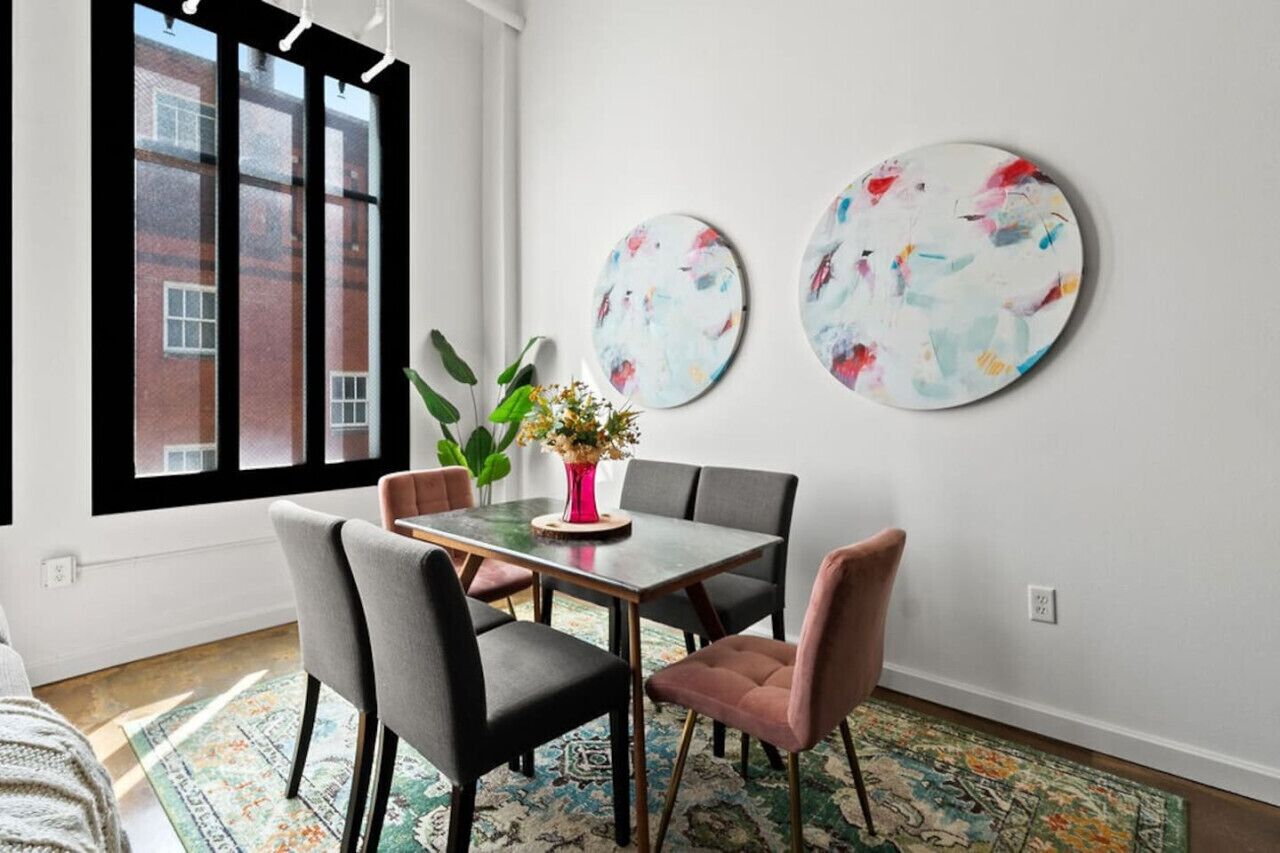 Modern dining space with vibrant art and natural light — ideal for gatherings.