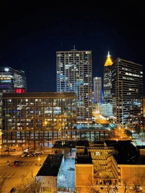 A cityscape at night with illuminated buildings and a parking area. - High Rise Condo Downtown ATL with Views (Atlanta)