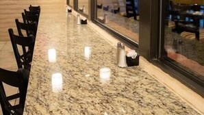 A restaurant interior with a long counter, hanging pendant lights, and large windows. - Scottsdale Camelback Resort Spacious 2BR Condo with Picnic Area (Scottsdale)
