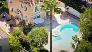 A multi-story building with a tiled roof, a swimming pool, and surrounding greenery. - Cannes Villa center pool spa classified (Cannes)